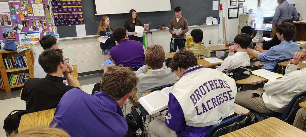 Three student presenters share their experiences as Jewish teens in a high school classroom, engaging an audience of fellow students.